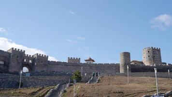 Ancient stone fortress with towers. Action. Fabulous view of stone fortress with towers in medieval style. Beautiful stone fortress with strange medieval architecture in summer video