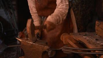 An adult man who works with iron. Media. Work with tapping on iron on special equipment with high temperature. video