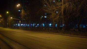 Empty street at night with road and lanterns. Concept. Lights are flashing on empty night street with driveway. Empty driveway with lanterns at night video