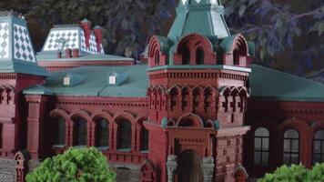 A large model of the red palace. Stock footage. A huge DIY of beautiful buildings, shot on the street next to the foliage. video