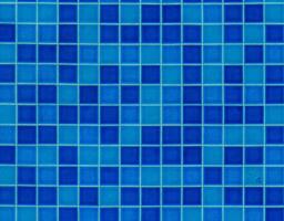 Vibrant blue mosaic tiles create a calming atmosphere in a tranquil swimming pool area during midday sunlight photo