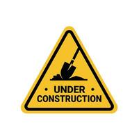 under construction at a site, shovel and soil on the yellow triangle sign. Suitable for posters and web icons vector