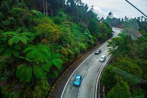 The stunning view in Genting highlands from a cable car as they go down a hill with a foggy in the background, Rainforest, Malaysia. Bird's eye view. Aerial view. photo