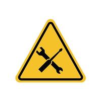 under construction in a building, a wrench and a screwdriver crossed on a yellow triangle sign. Suitable for posters and web icons vector