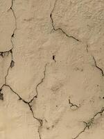 A close up of a cracked wall with cracks photo