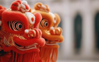 Two colorful lion dance costumes with intricate designs and vibrant details against a blurred background. photo