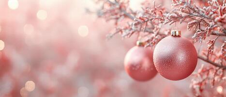 Close-up of beautiful pink Christmas ornaments hanging on a frosted tree branch, creating a soft, festive atmosphere with bokeh background lights for a holiday feel. photo