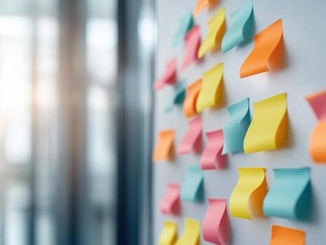 Colorful sticky notes on a wall, symbolizing ideas and collaboration in a modern office environment. photo