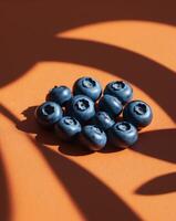 Blueberries on orange background photo