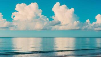 A beach with a large body of water and some clouds photo