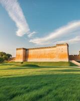 The old castle in the middle of a green field photo
