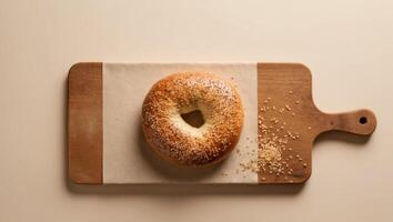 Bagel on a cutting board with sesame seeds photo