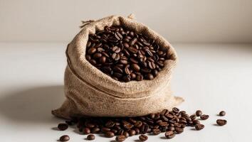 Coffee beans in a bag on a white table photo