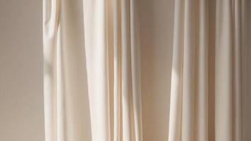 A white curtain is hanging in front of a window photo