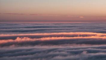 A view of the clouds from an airplane at sunset photo