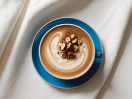 Nutty latte with hazelnuts and hazelnut spread on a white bed photo