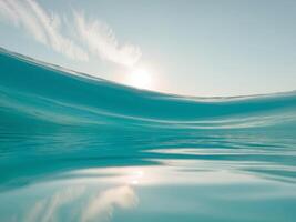 A wave in the ocean with a sun in the background photo