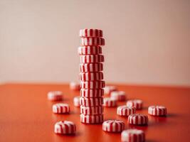 A stack of red and white candy on a table photo