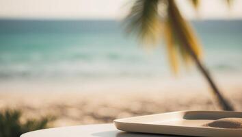 A white plate with sand on the table in front of a beach photo