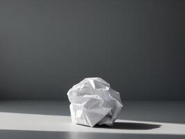 A crumpled ball of paper sitting on a table photo