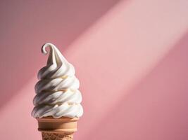 An ice cream cone with white frosting on a pink background photo