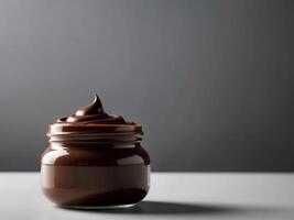 A jar of chocolate spread on a table photo
