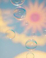 Bubbles floating in the air with a sun in the background photo