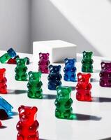 Gummy bears on a white table with a white cube photo