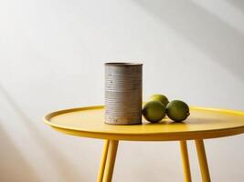 A yellow table with a tin can and lime photo
