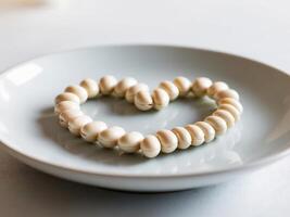 A white plate with a heart shaped cookie photo