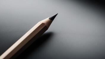 A close up of a pencil on a black surface photo