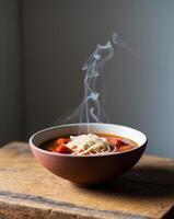 A bowl of soup with a steam rising from it photo