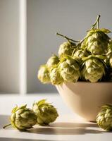 A bowl of hops sitting on a table photo