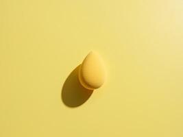 A yellow sponge on a yellow background photo