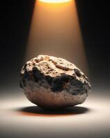 A rock is shown in front of a spotlight photo
