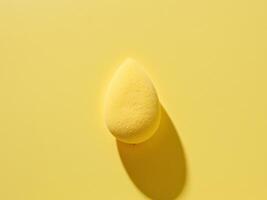 A yellow sponge on a yellow background photo