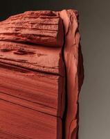 A close up of a red rock with a black background photo