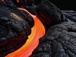 A lava flow is flowing into a black rock photo