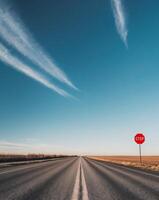A stop sign on the side of a highway photo