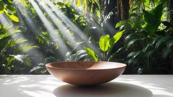 A bowl sitting on a table in front of a tropical forest photo
