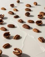 Pecan nuts on a white surface photo