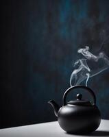 Black tea pot with smoke on a table photo