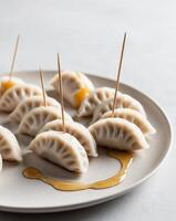 A plate with dumplings and toothpicks on it photo
