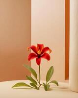 A red flower sits on a table in front of a wall photo