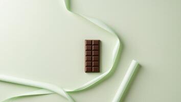 A chocolate bar on a green background photo