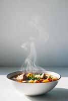 A bowl of soup with steam rising from it photo