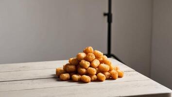 A pyramid of doughnuts sitting on top of a table photo