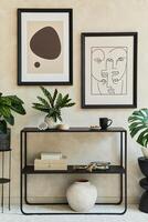 Creative composition of stylish modern living room interior with mock up poster frames, black geometric commode, plants and personal accessories. Neutral colors. Template. photo