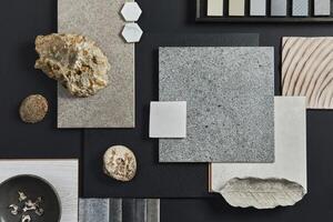 Flat lay composition of creative black architect moodboard with samples of building, textile and natural materials and personal accessories. Top view, black background. photo