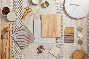 Flat lay design of creative architect moodboard composition with samples of building, beige textile and natural materials and personal accessories - Top view. Template. photo